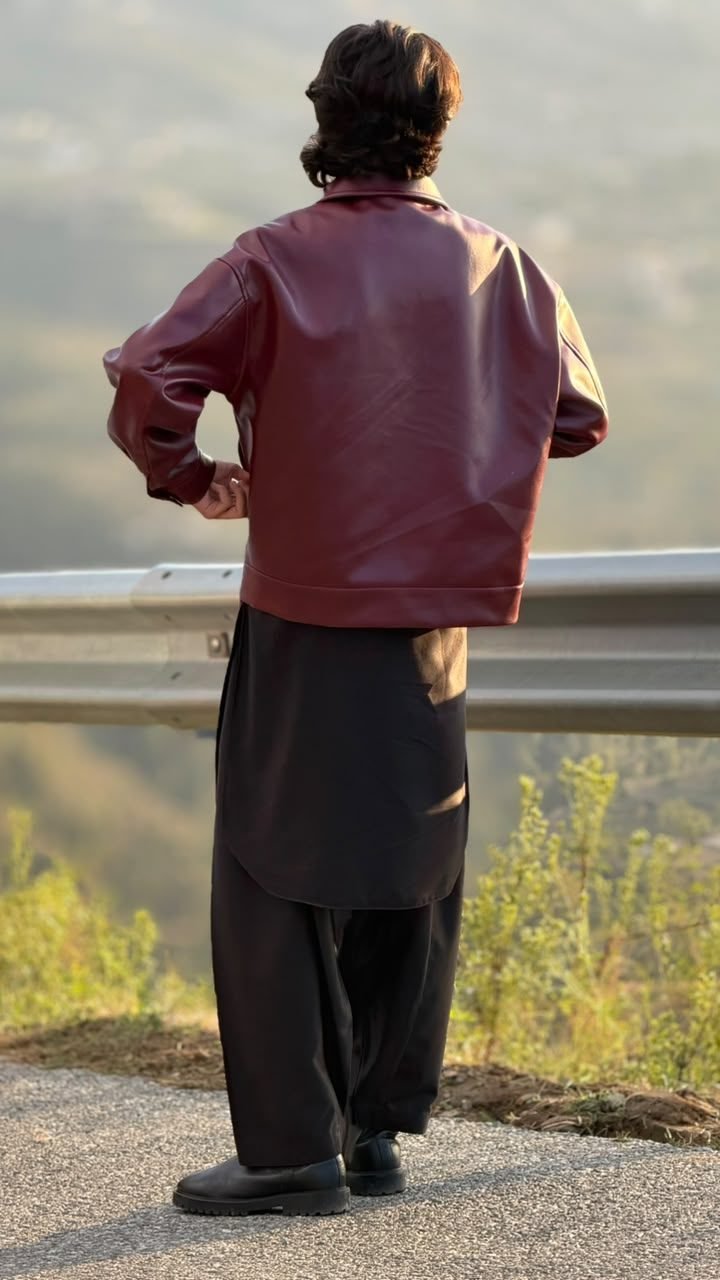 Back view of the burgundy leather jacket at sunset